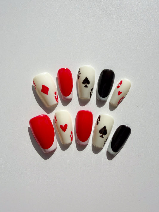 Nail art designs with playing card symbols on a white background